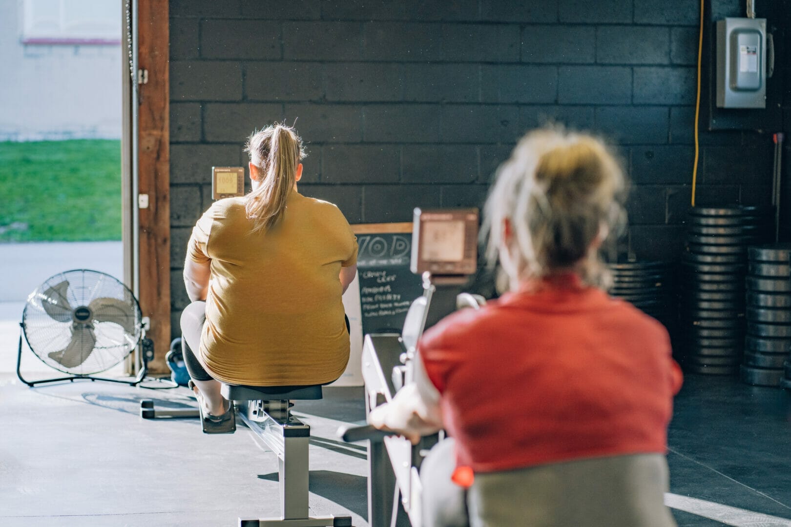 two women working out on rowers