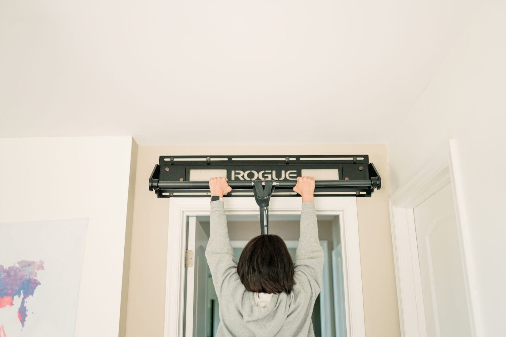 woman doing a pull up in her doorway